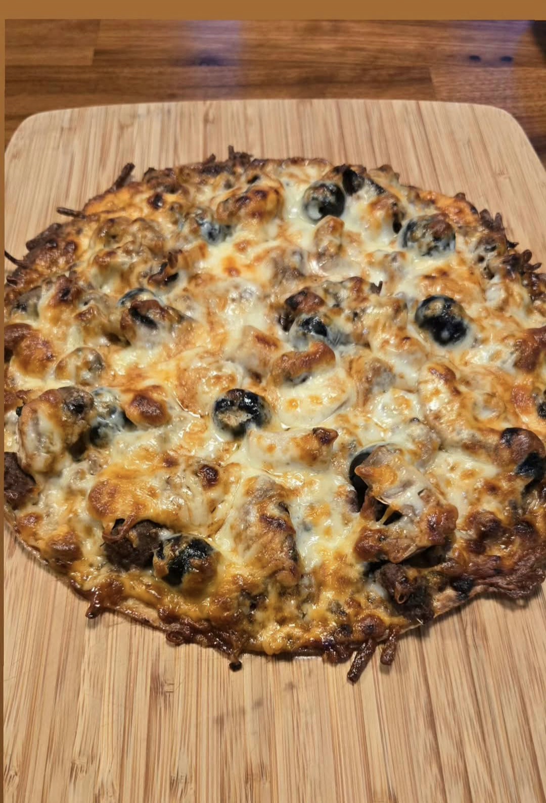 Homemade pizza with melted cheese and olives